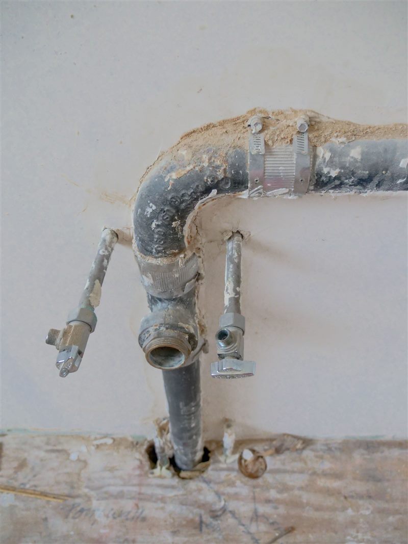 Plumber clearing a clogged drain
